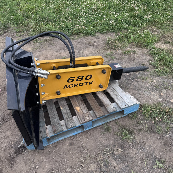 Skid steer hydraulic concrete breaker with moil point chisel on quick attach mount
