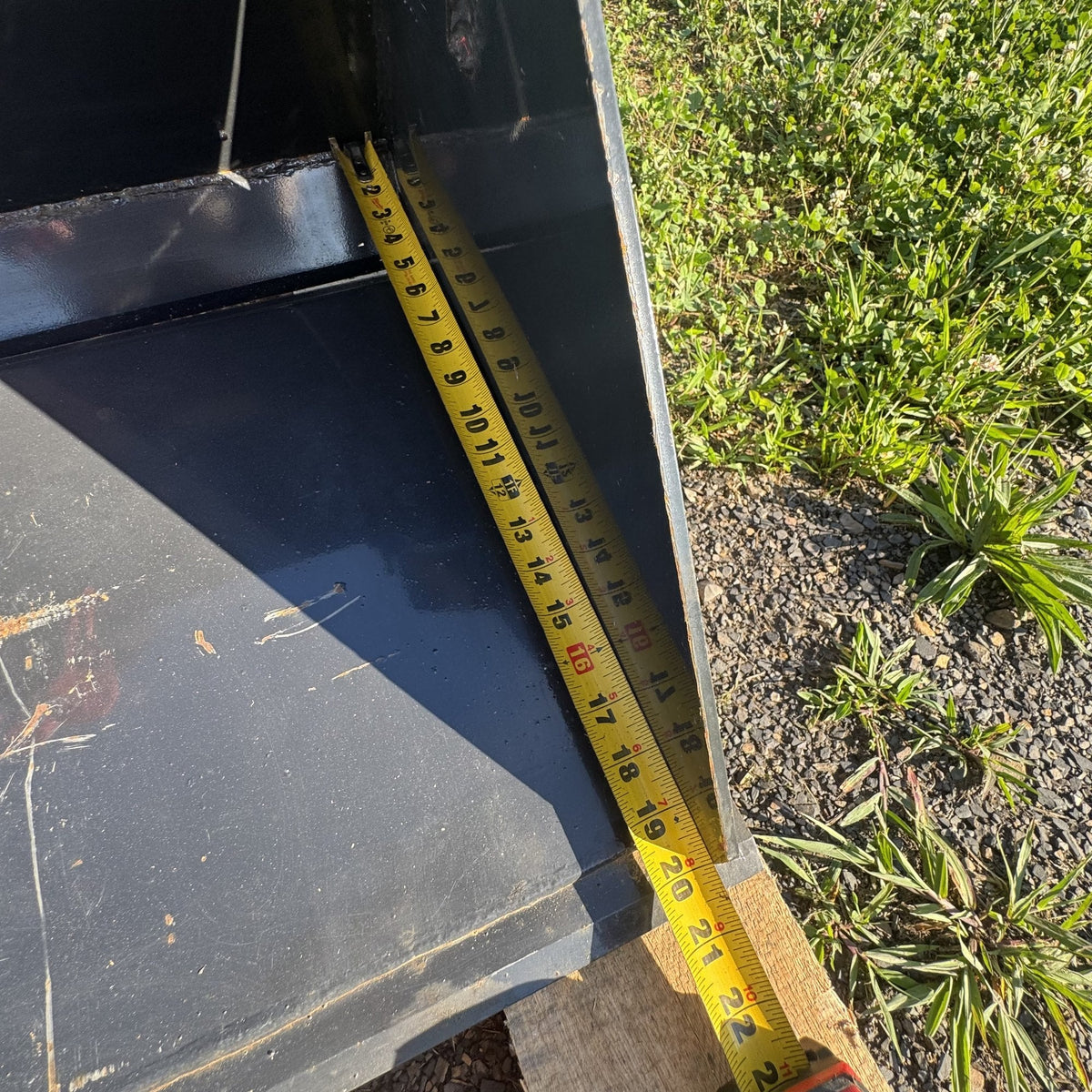 Tape measure showing bucket depth front to back