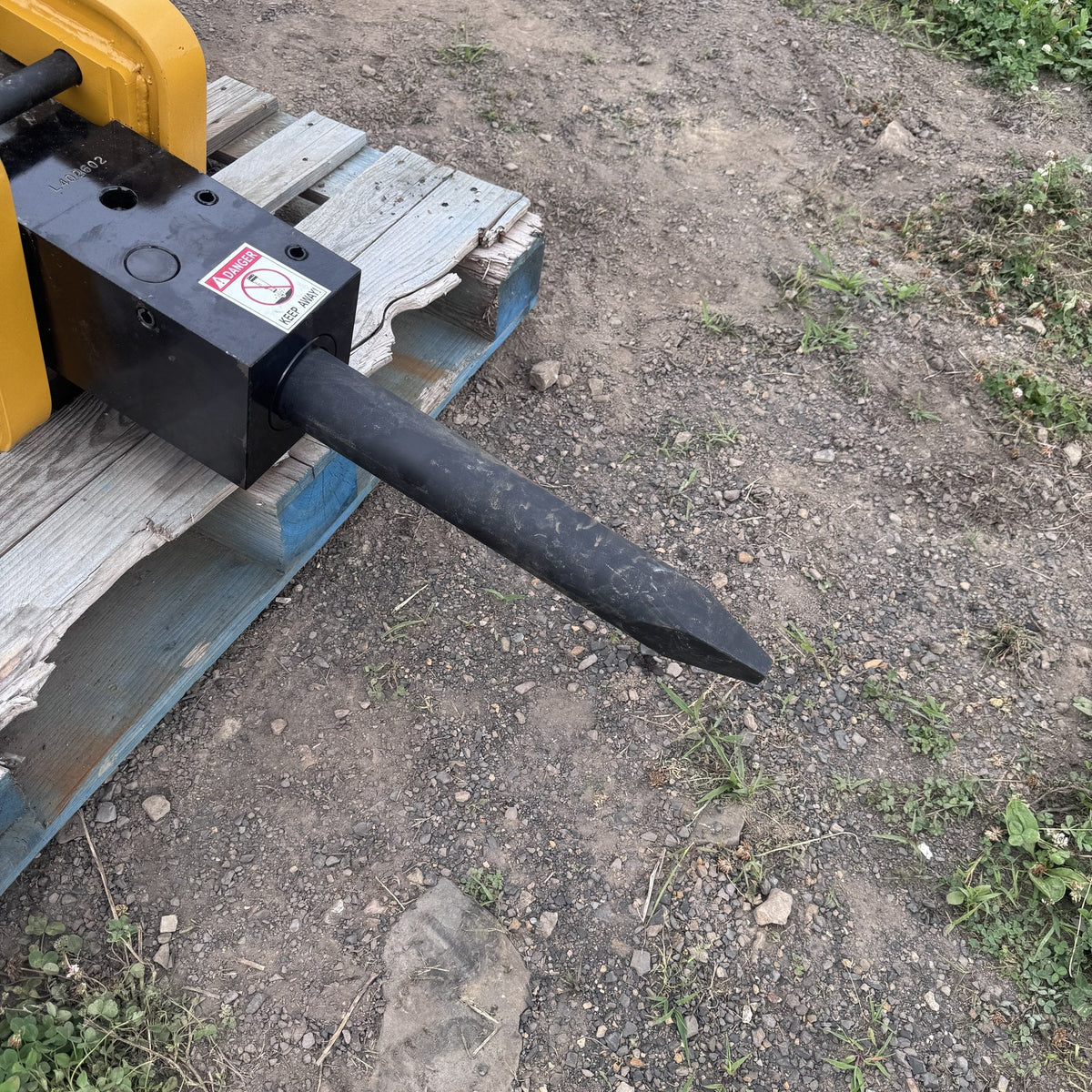 Close view of the breaker moil point chisel and lower housing