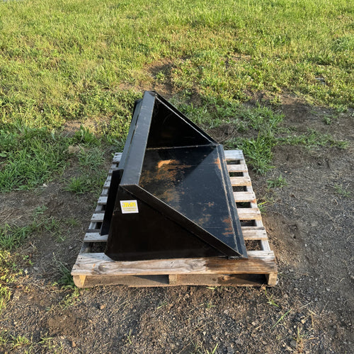 Dirt bucket three quarter view showing side plates and cutting edge