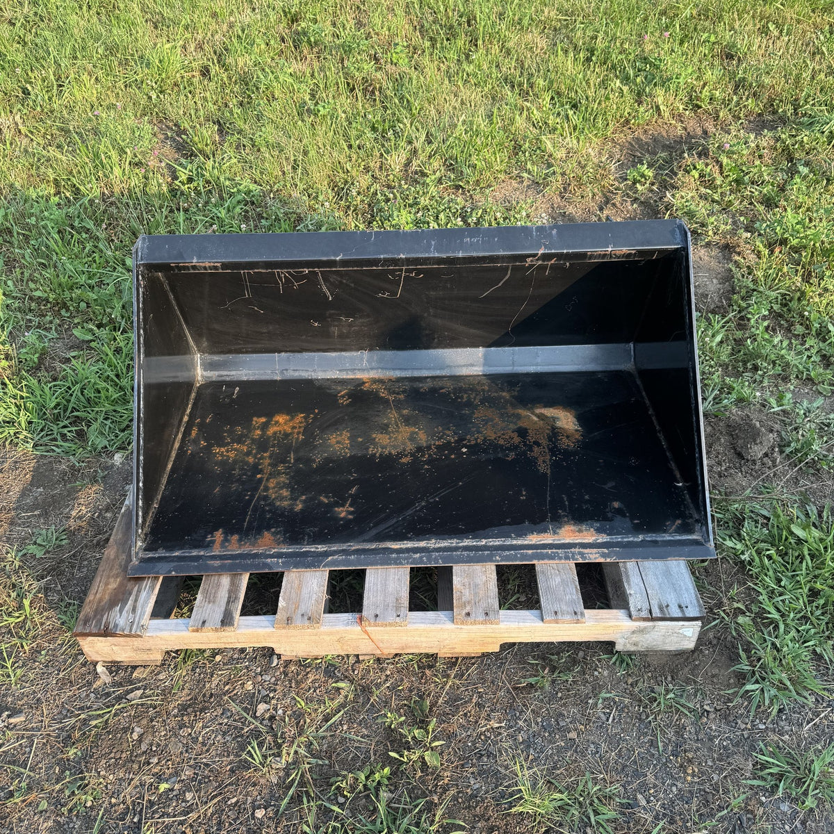 Looking down into the bucket showing the floor and back wall