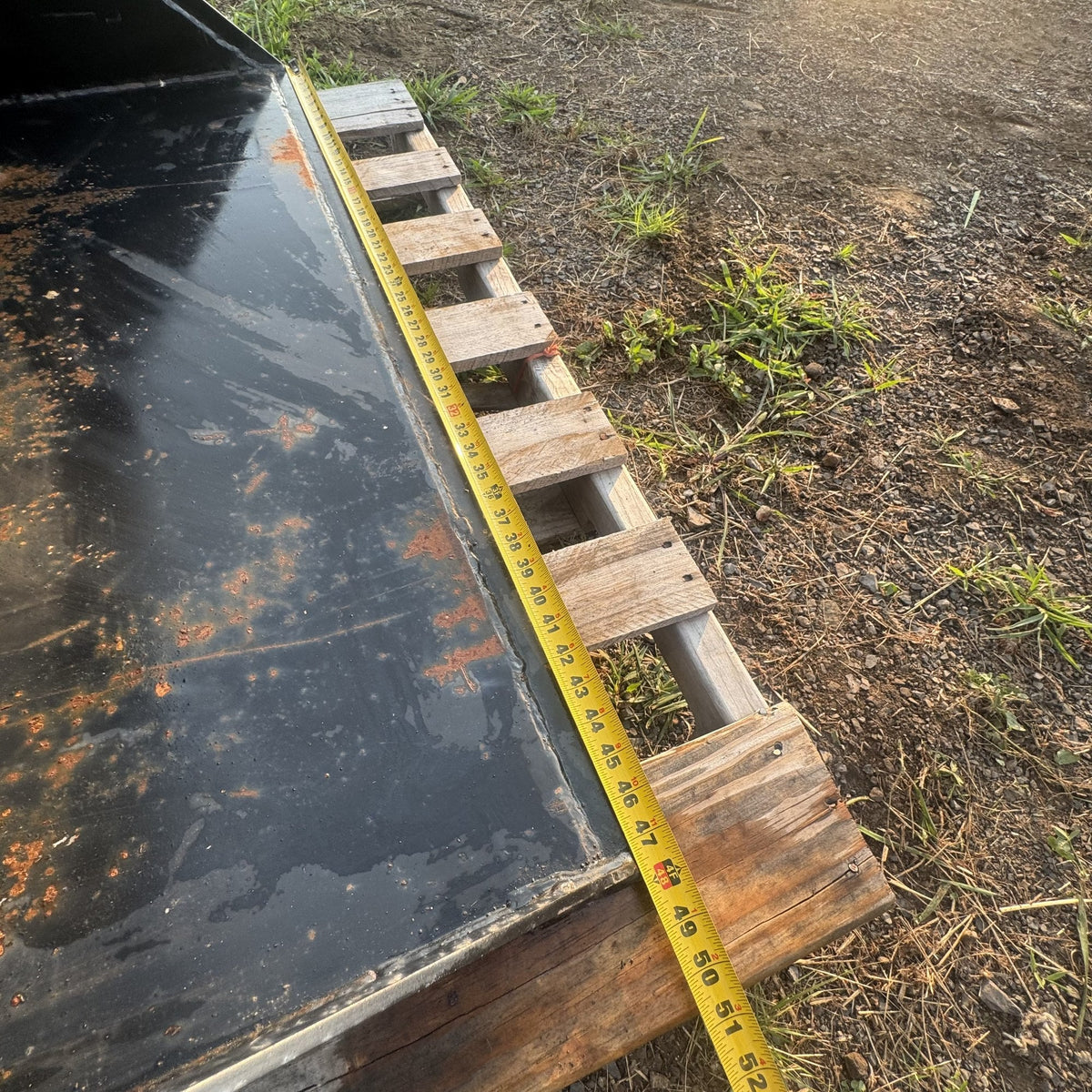 Tape measure across the cutting edge showing bucket width