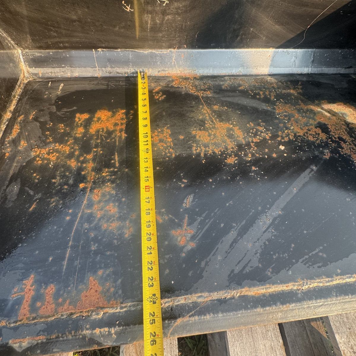 Tape measure showing bucket depth front to back