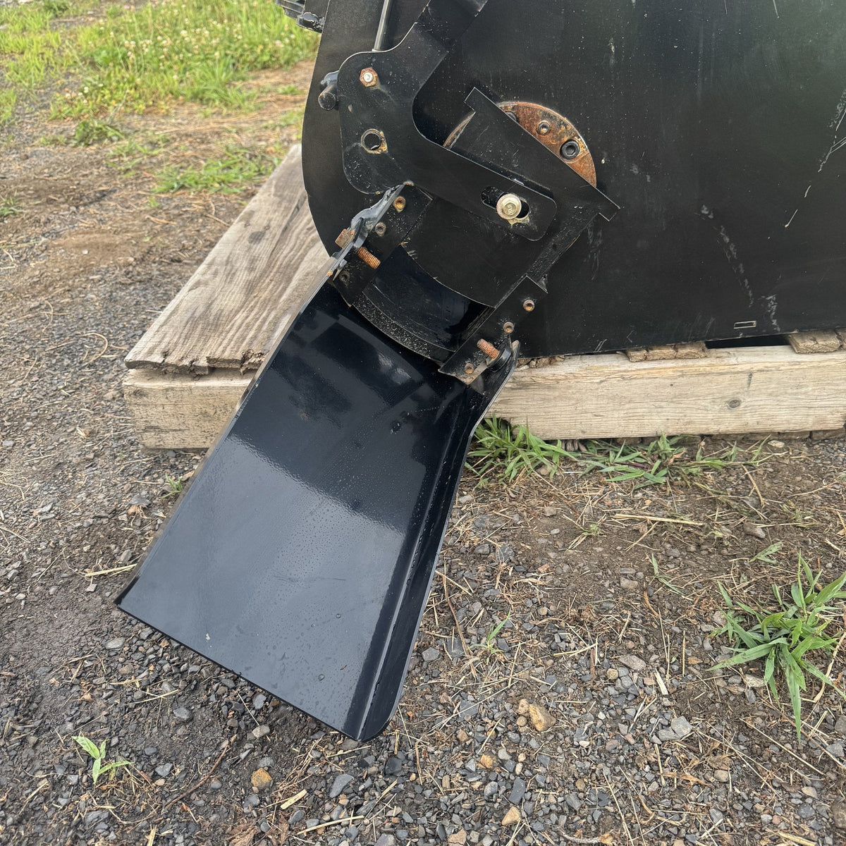 Close view of the pour chute and its latch linkage