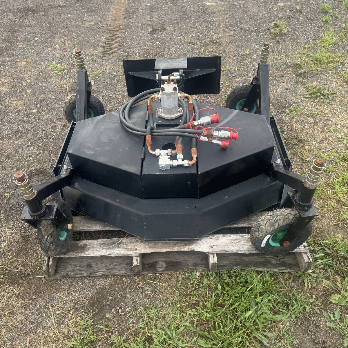 Finish mower deck with all four caster wheels visible