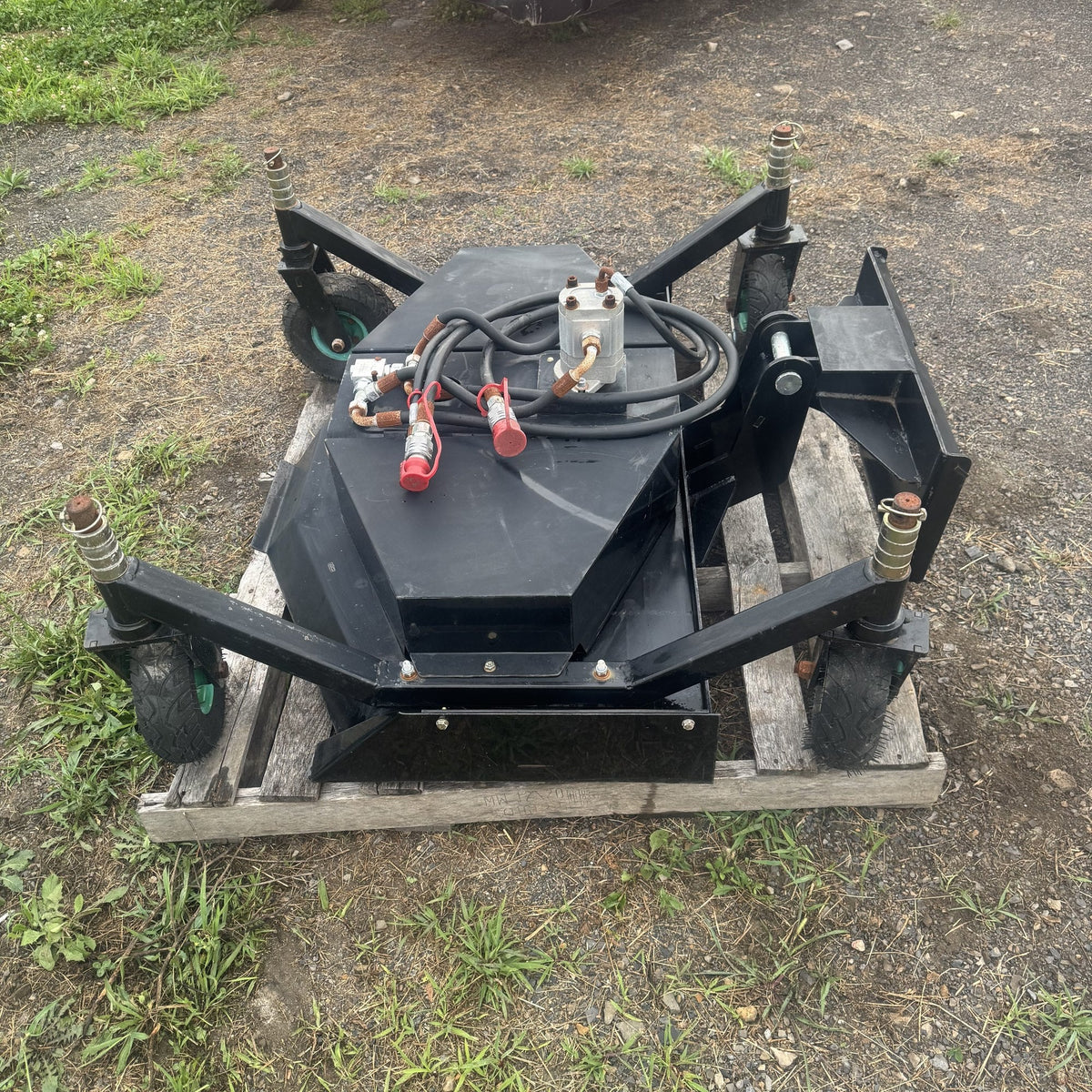 Top of the finish mower deck showing hydraulic motor and hoses